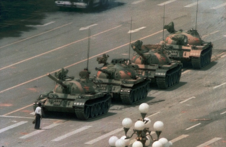 Image: A Chinese man stands alone to block a line of tanks