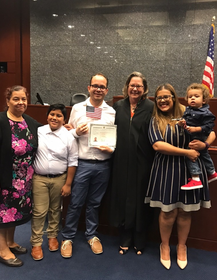 Rudy Zamora stands alongside his family and Magistrate Judge Peggy A. Leen moments after he took the oath to become a U.S. citizen. (Left to right) Zamora's mother Reyna Padilla, brother Rafael Rodriguez, Jude Peggy A. Leen, wife Emily Zamora and son William Zamora.