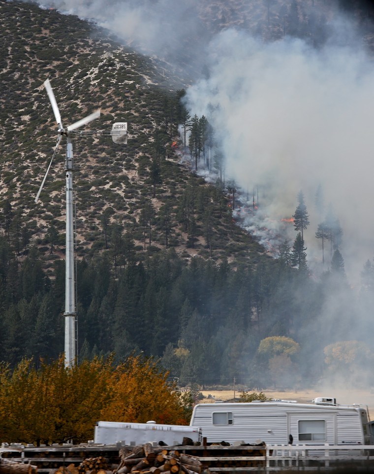 Image: The hills above Franktown Road burn Friday afternoon as the Little Valley Fire spreads.