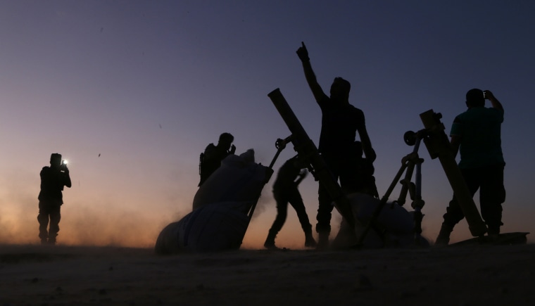Image: Syria rebel fighters cheer as they fight ISIS jihadists on the outskirts of the northern Syrian town of Dabiq.