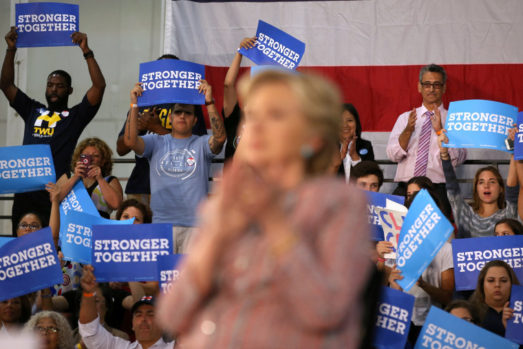 Image: Supporters listen to U.S. Democratic presidential nominee Clinton and former Vice President Al Gore talk about climate change at a rally at Miami Dade College in Miami