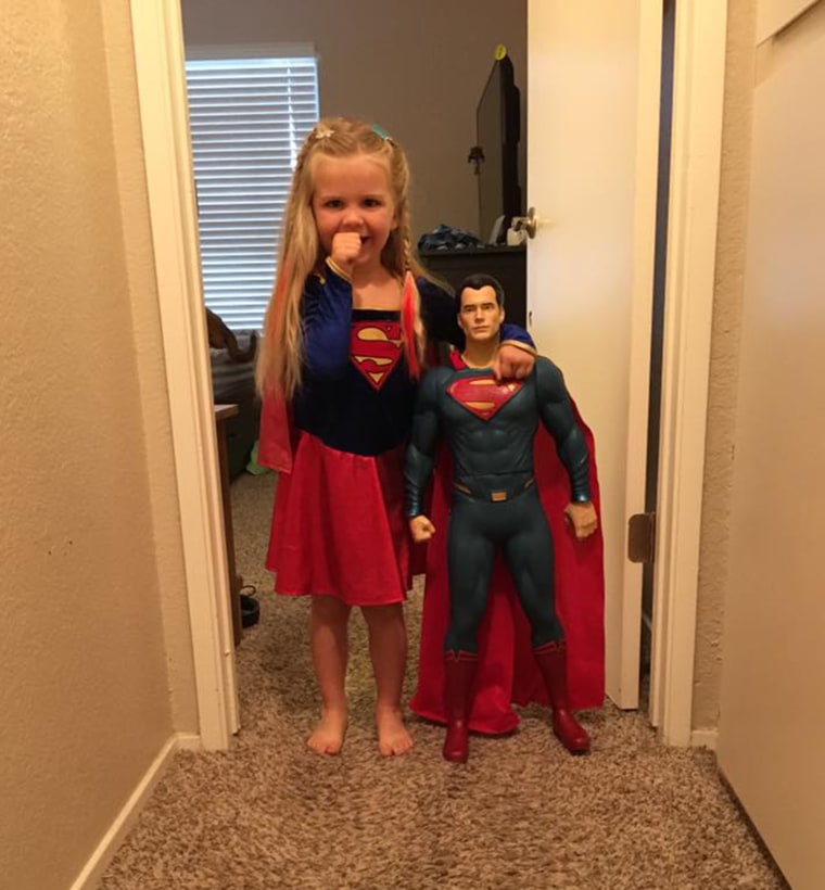 Kaylieann poses next to her Superman doll! 