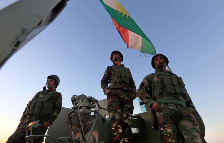 Image: Iraqi Kurdish Peshmerga fighters hold a position on the top of Mount Zardak