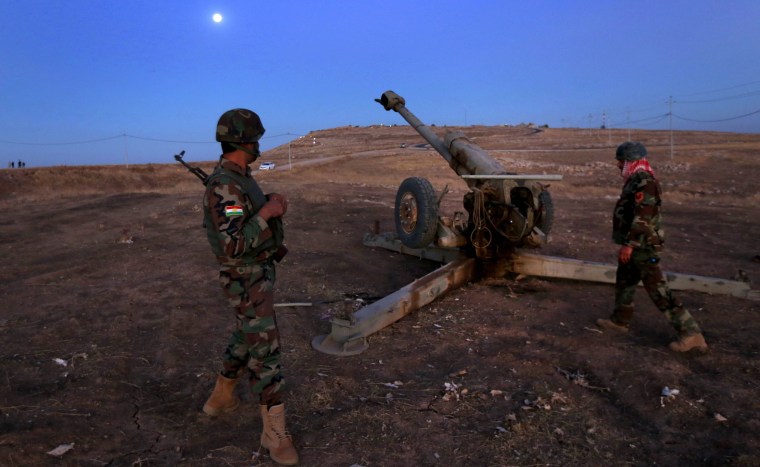 Image: Iraqi Kurdish Peshmerga fighters hold a position on the top of Mount Zardak