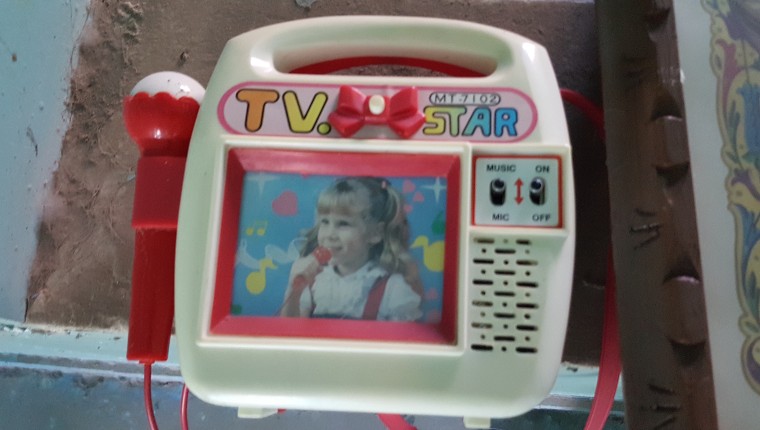 A toy karaoke machine that Griselda Nevarez played with as a kid; still in the house in Mexico that her parents left behind. 