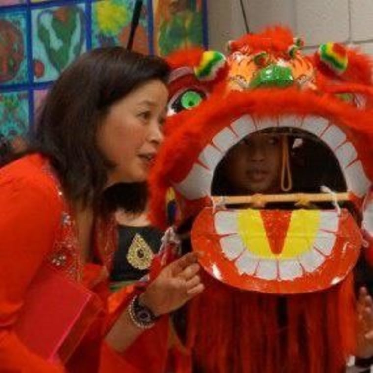 Frances Kai-Hwa Wang with son Di Di who is about lion dance for the grand finale at his elementary school's international night event, which she chaired for ten years.