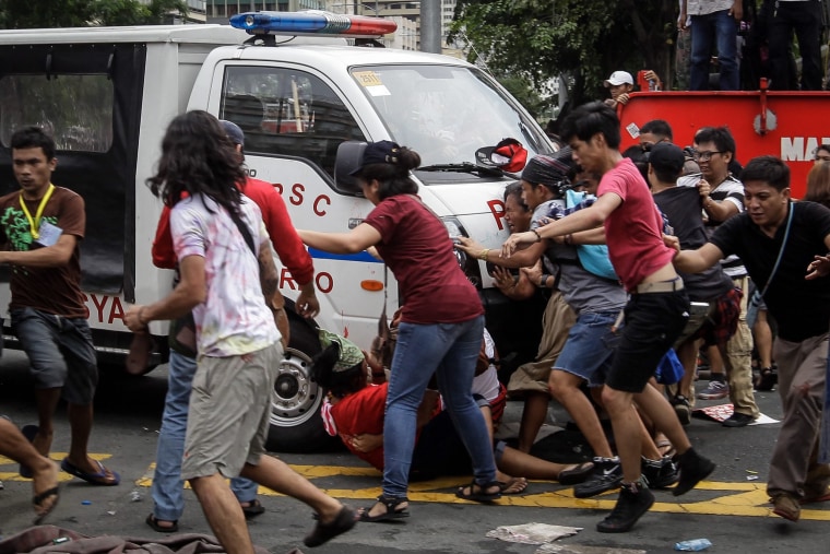 Image: Filipinos clash with police during a protest at the US Embassy in Manila