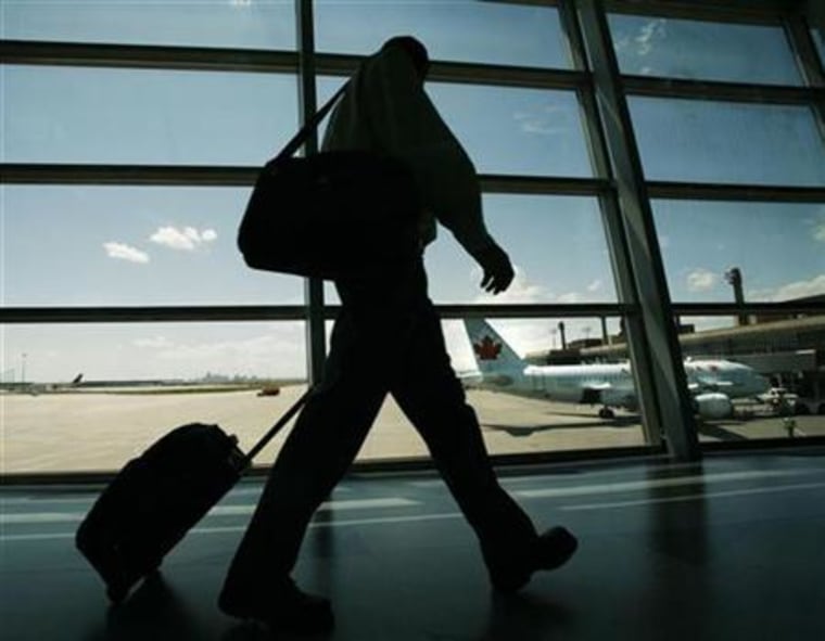 An Air Canada passenger walks to catch his plane