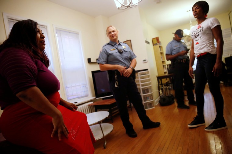 Image: Hawkins speaks with Corado at a home where she shelters transgender women of color in Washington