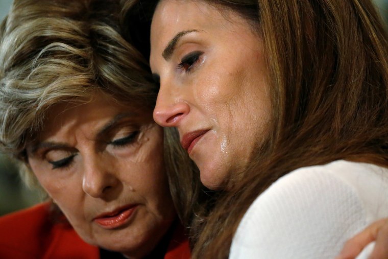 Image: Lawyer Gloria Allred hugs crying Karena Virginia