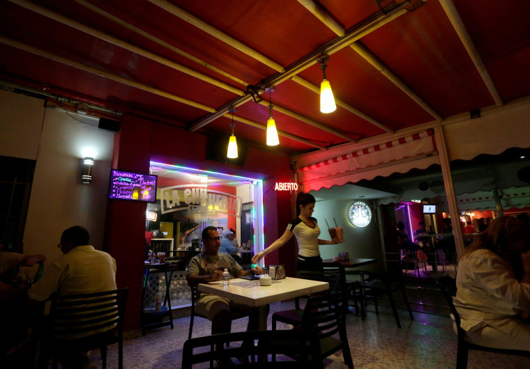 Image: People eat at a private restaurant in Havana, Cuba