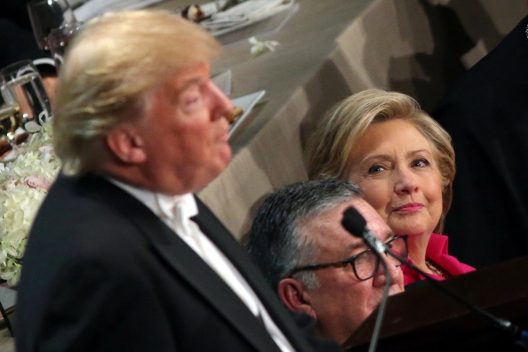 Image: Hillary Clinton looks at Donald Trump as he speaks during the Alfred E. Smith Memorial Foundation dinner in New York