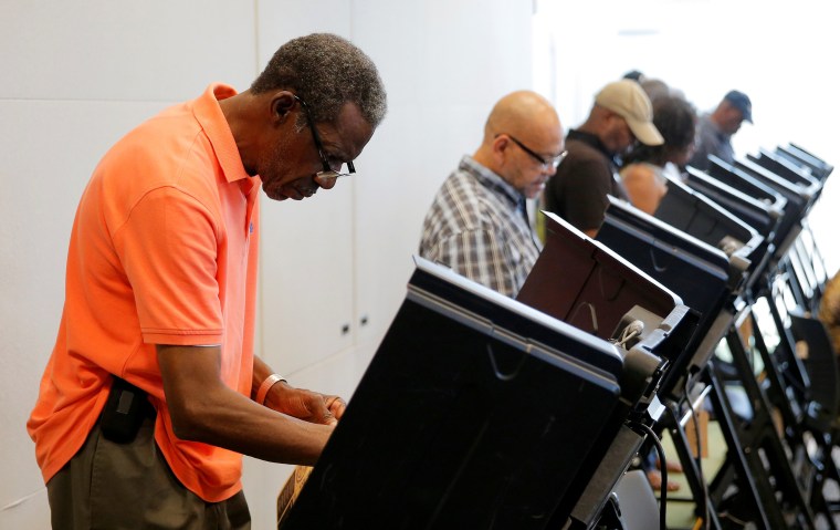 Image: Voters cast their ballots during early voting at the Beatties Ford Library in Charlotte, North Carolina