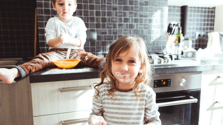 Siblings cooking in the kitchen