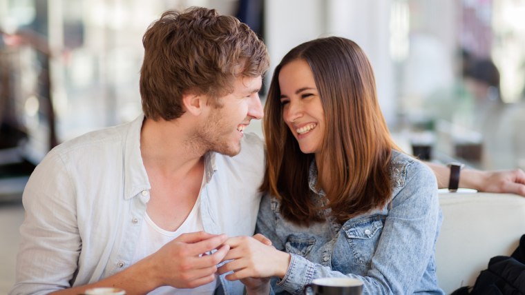 Young couple smiling in a coffee shop