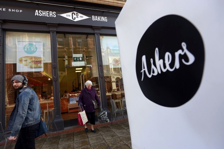 Image: A woman leaves Ashers bakery in Belfast