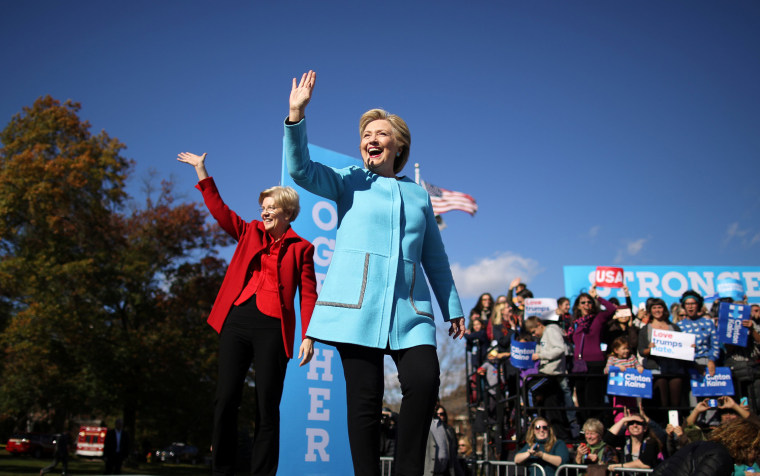 Image: Democratic U.S. presidential nominee Hillary Clinton waves as she arrives to a campaign event accompanied by U.S. Senator Elizabeth Warren (D-MA) at Alumni Hall Courtyard, Saint Anselm College in Manchester, New Hampshire U.S.
