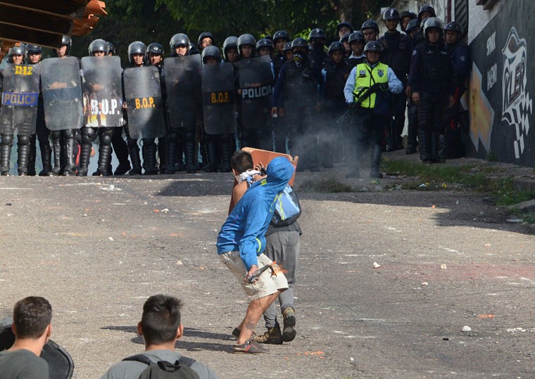 Image: Riot police agents confront students