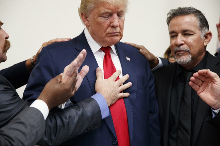 Image: Pastors from the Las Vegas area pray with Donald Trump