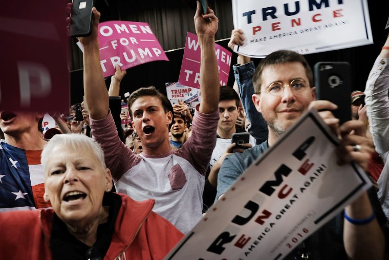 Image: People cheer as Republican presidential candidate Donald Trump speaks at a rally