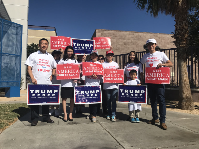 Volunteers with Chinese Americans for Trump with signs.