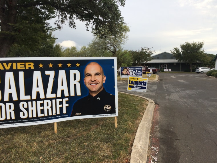 The tight race at the top of the ballot in deep red Republican Texas has some Democrats hoping for victories down ballot, including in the Bexar County sheriff's race. A sign for the Democratic candidate John Salazar stands outside the early voting location in Leon Valley, Texas.