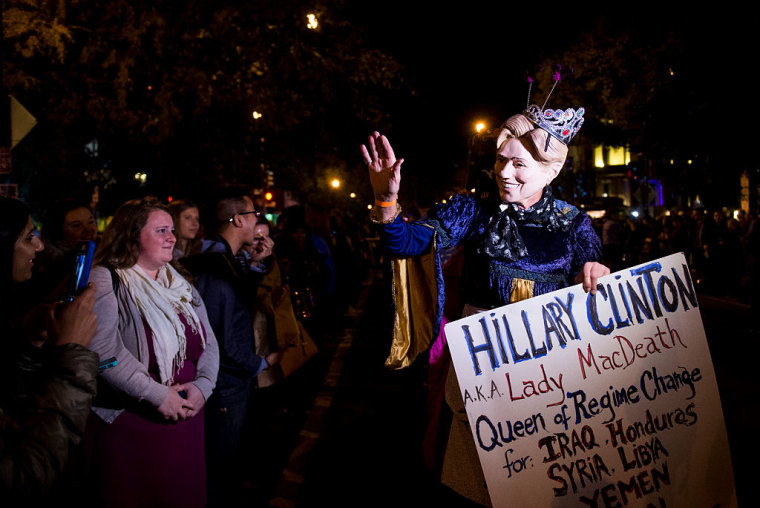 A Hillary Clinton impersonator waves to the crowd during a costume parade before the start of the 30th Annual 17th Street High Heel Race in Washington on Tuesday, Oct. 25, 2016.