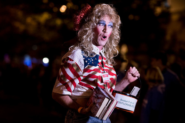 "Darlene Deplorable" carries books by right-wing figures during costume parade before the start of the 30th Annual 17th Street High Heel Race in Washington on Tuesday, Oct. 25, 2016.