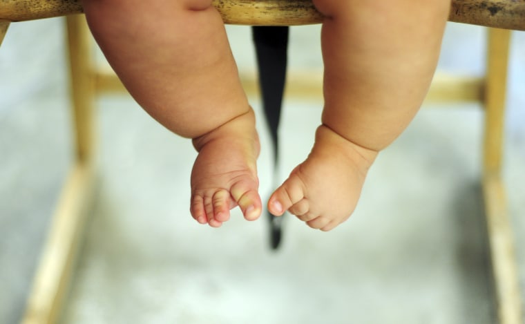 Dancing feet of overweight baby