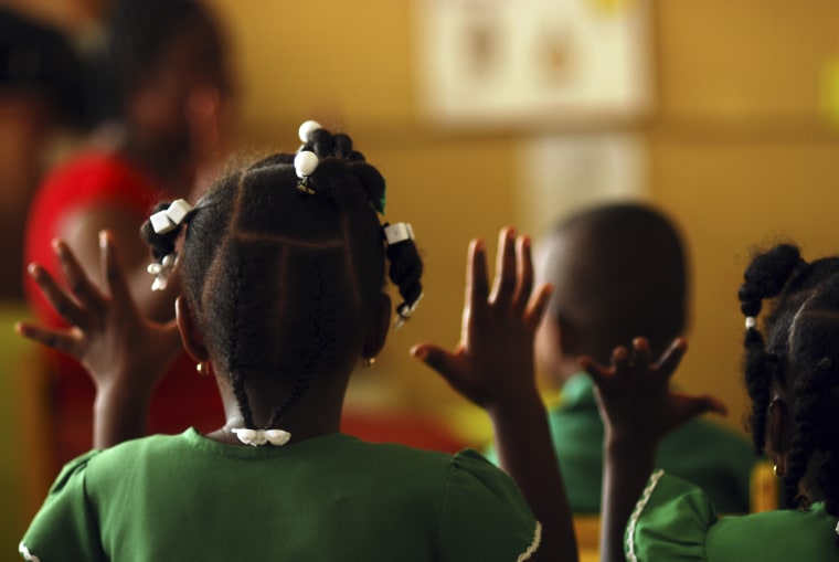 Dominica, Roseau, Preschool Social Center, rear portrait of girl with braids