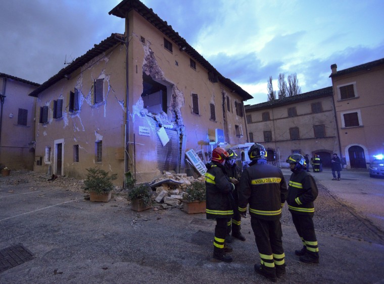 Image: Firefighters inspect the damage in Visso