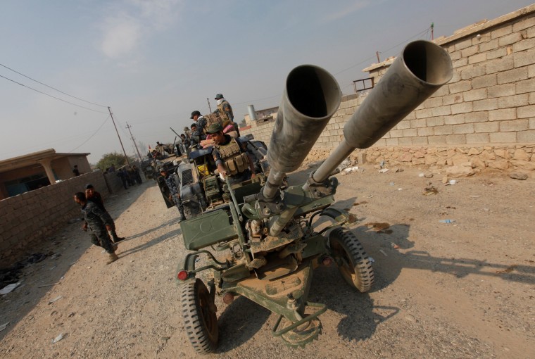 Image: Military vehicles during an anti-ISIS operation in Qayyara, Ir