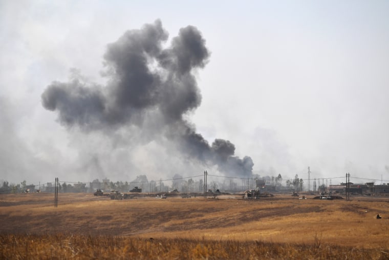 Image: Smoke billows from a combined aircraft, artillery and ground attack