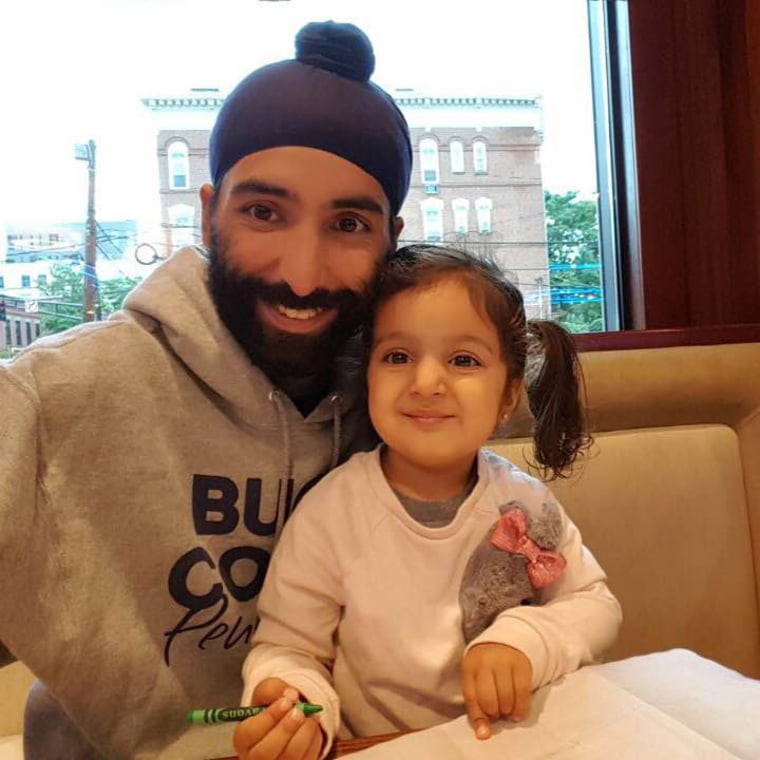 Agan Singh with his three-year-old daughter, Satya.