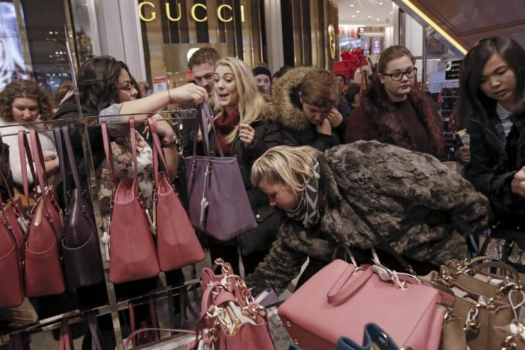 Women shop for handbags at Macy's Herald Square store during the early opening of the Black Friday sales in the Manhattan borough of New York
