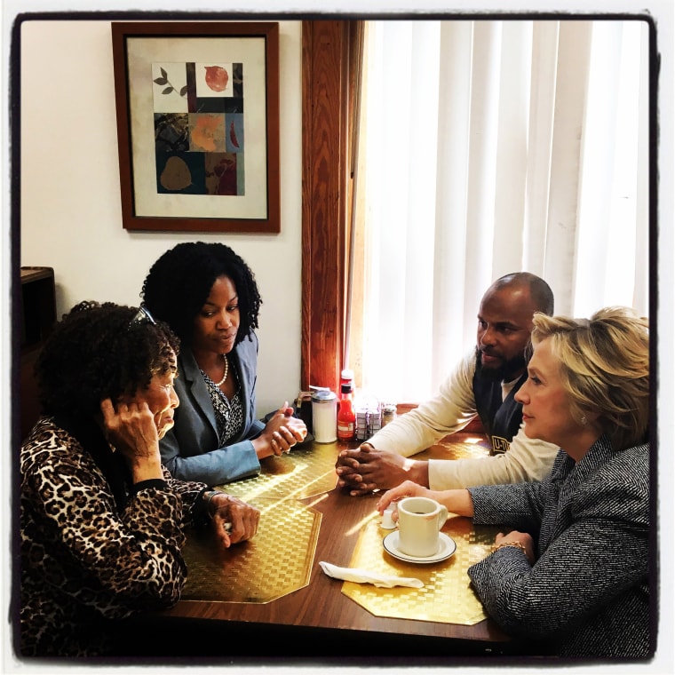 Image: Democratic presidential candidate Hillary Clinton has coffee with patrons at Cozy Spot