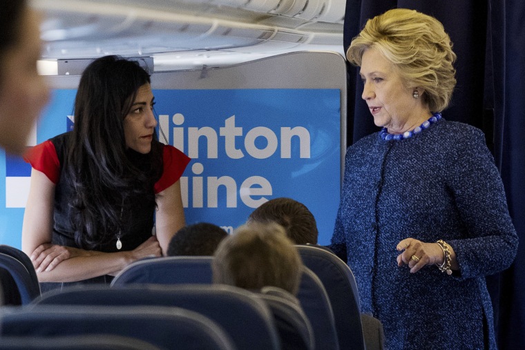 Image: Clinton speaks with senior aide Huma Abedin aboard her campaign plane