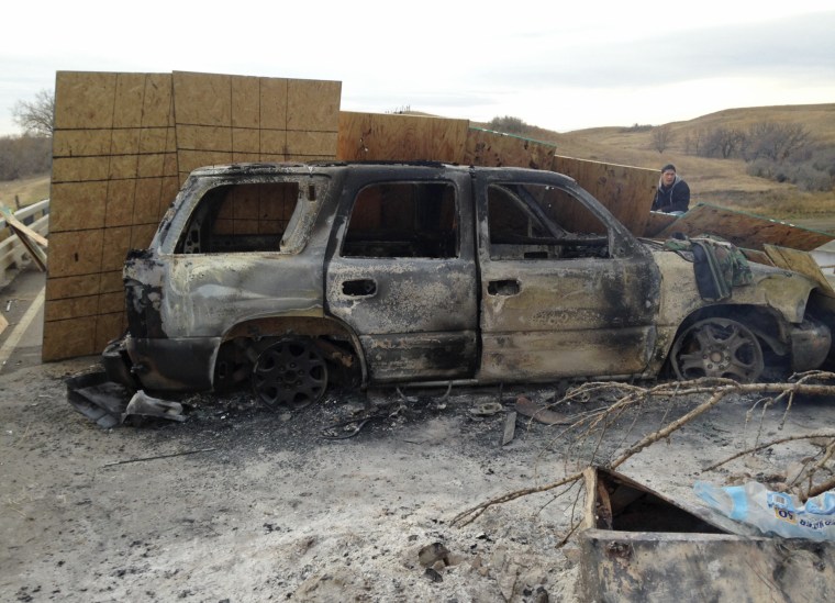 A burned-out truck sits on Highway 1806 near Cannon Ball, N.D., on Friday, Oct. 28, near the spot where protesters of the Dakota Access pipeline were evicted from private property a day earlier.