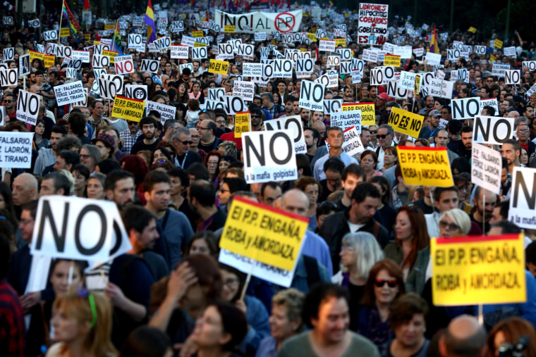 Image: Demonstrators attend a protest against the investiture of acting Prime Minister and Popular Party leader Mariano Rajoy in Madrid