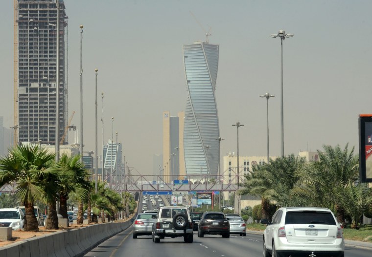 Image: Saudi commuters drive down a main street in the capital Riyadh