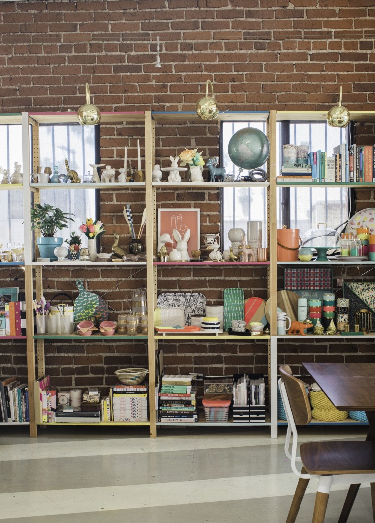 Simple shelves streamline the endless props and creative tools used by the studio.