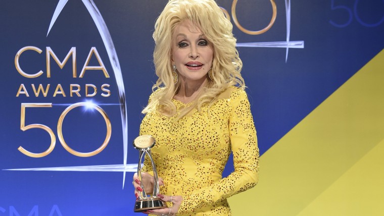 Dolly Parton poses in the press room with the Willie Nelson Lifetime Achievement Award during the 50th annual CMA Awards at the Bridgestone Arena on Wednesday, Nov. 2, 2016, in Nashville, Tenn.