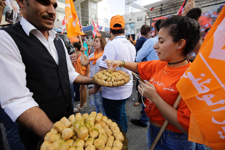 Image: Sweets are handed out in Batroun, Lebanon
