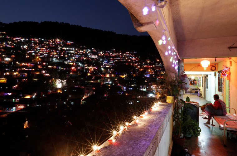 Image: People decorate their houses with lanterns and lights as they celebrate the annual Hindu festival of Diwal in Mumbai