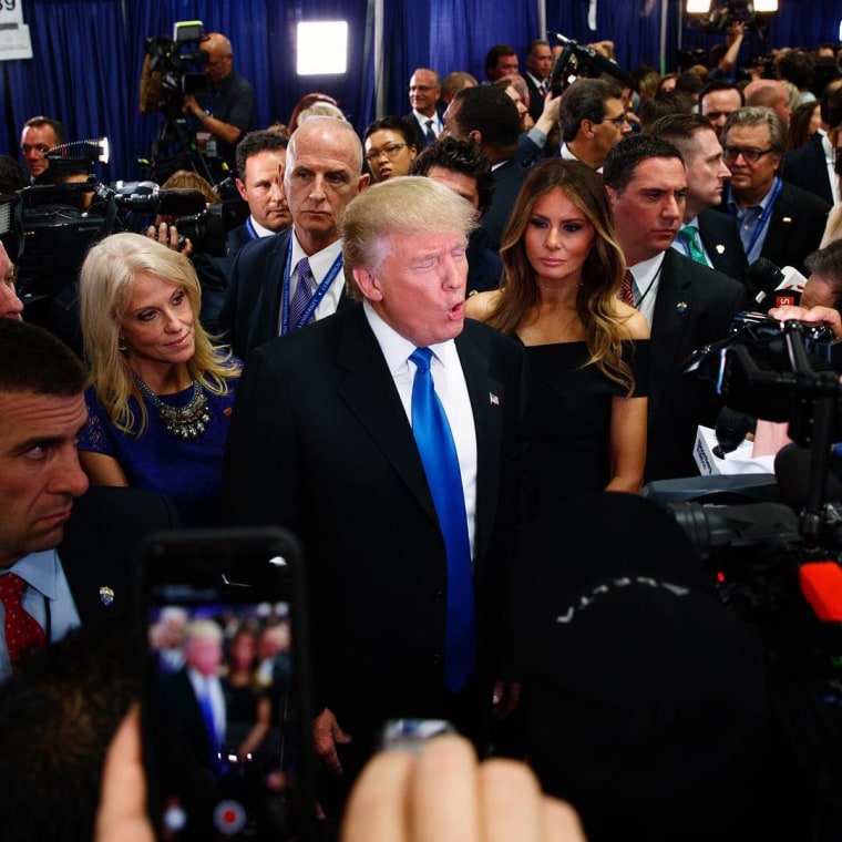 Image: Trump speaks with reporters in the spin room after the first presidential debate
