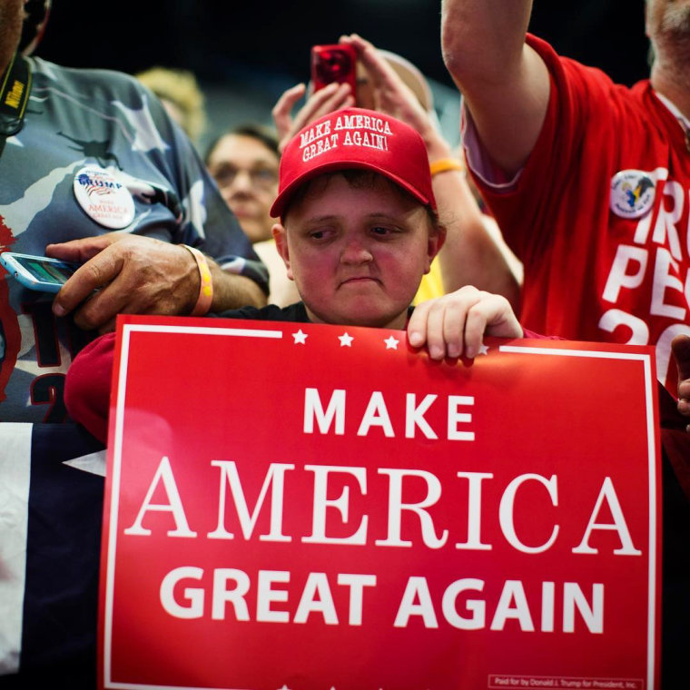 Image: Trump supporters listen as he speaks during a campaign rally in Eau Claire