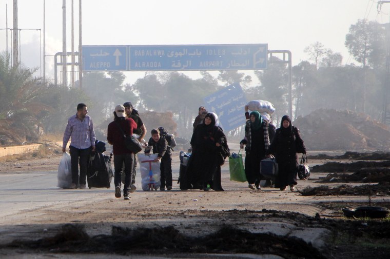 Image: Syrians carry their belongings as they leave Aleppo on Oct. 30, 2016