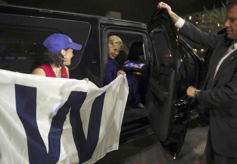 Image: Clinton holds a 'W' banner as the Chicago Cubs win the World Series