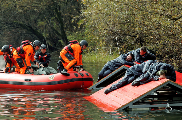 Image: Rescue workers evacuate mock flood victims as part of an international field exercise in Podgorica