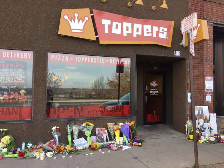 A makeshift memorial to Hussain Saeed Alnahdi grows outside Toppers Pizza in Menomonie, Wisconsin.